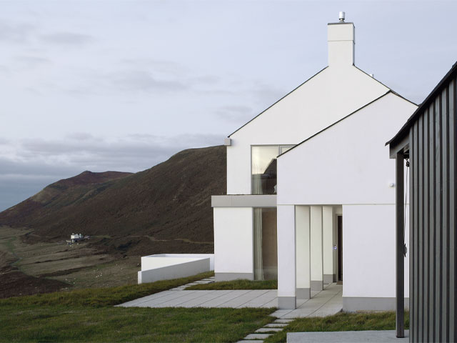remote home with air source heat pump on Gower Peninsula by Maich Swift