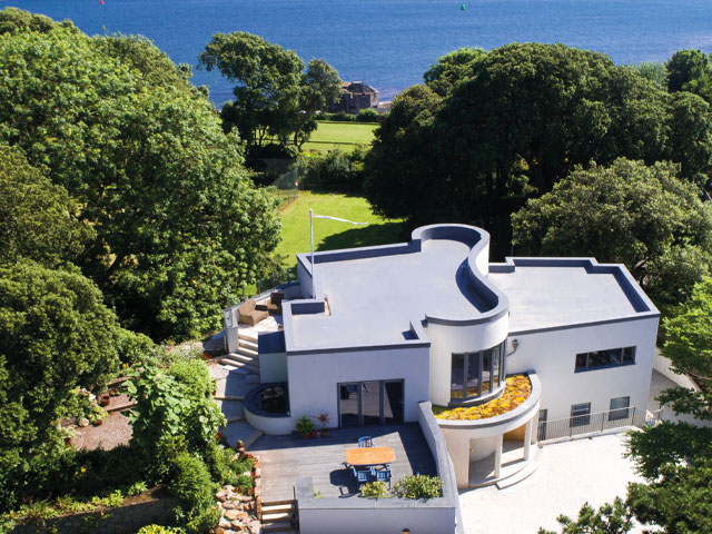 house designs for sloping sites: built with insulated concrete formwork strong enough to create a retaining wall next to the limestone hillside