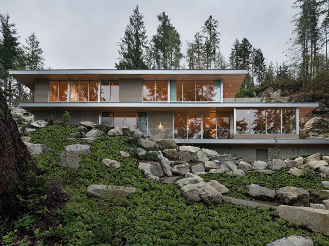 house designs for sloping sites: this Vancouver home sits on a platform carved from a steep rocky slope
