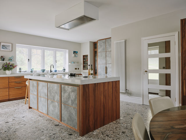 large kitchen with walnut veneer and zinc panels on the large kitchen island