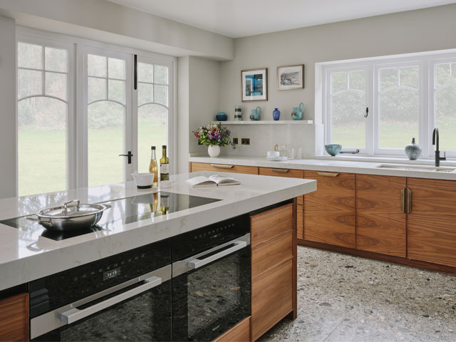 large kitchen with walnut veneer and zinc panels on the large kitchen island 