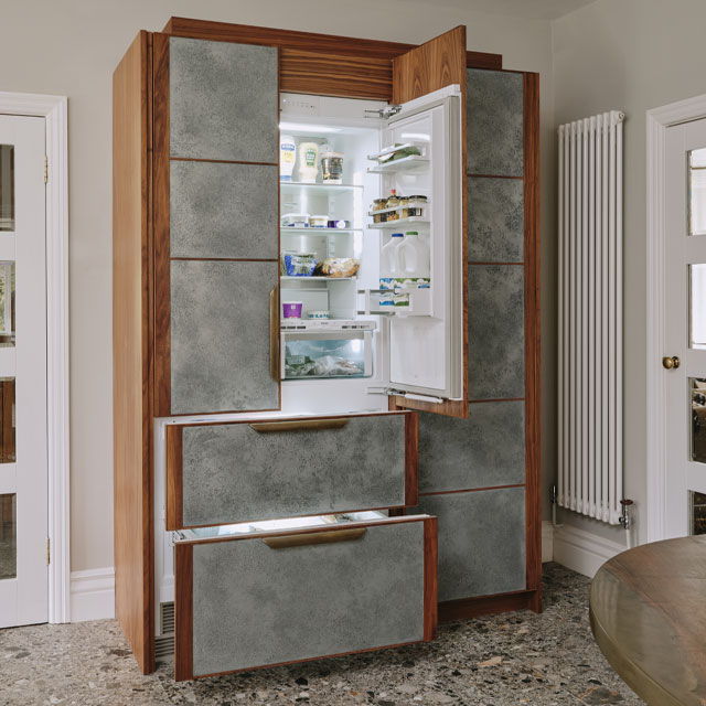 bespoke kitchen cabinet hiding the fridge freezer with zinc panels and walnut veneer