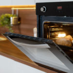 Oven in modern kitchen baking bread