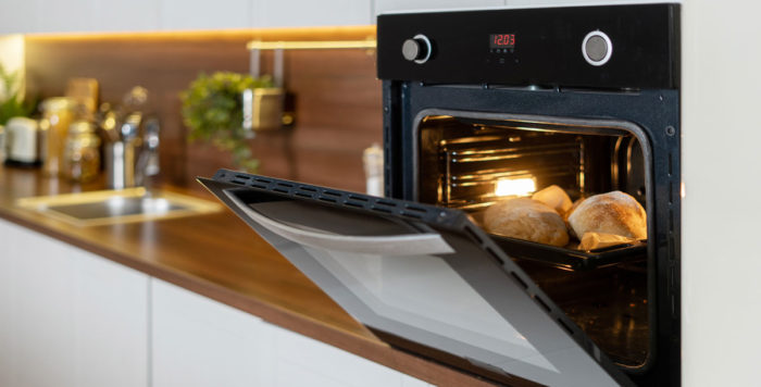 Oven in modern kitchen baking bread