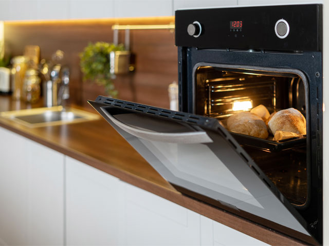 Oven in modern kitchen baking bread
