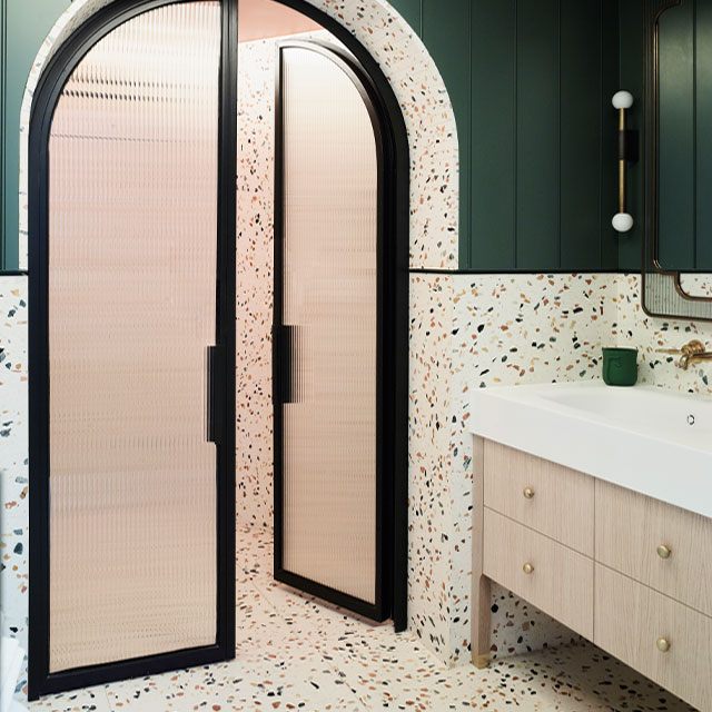 wet room created in a large bathroom with doors closing it off to the dry area