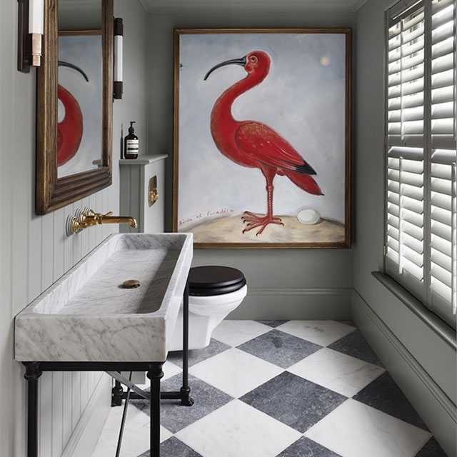 marble trough sink, chequered floor and large artwork in a small cloakroom WC designed by Tom Cox of Hám Interiors