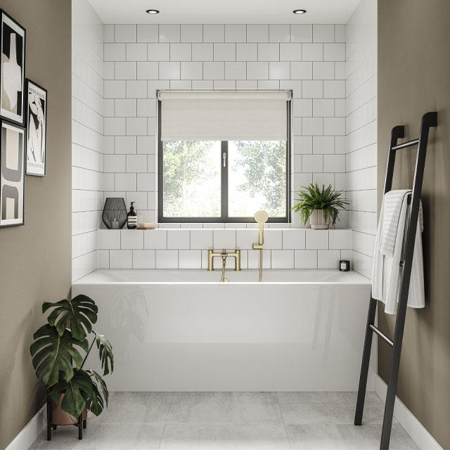 bathtub fitted wall-to-wall under a window in a small bathroom