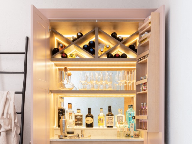 bespoke cocktail cabinet with wine storage, mirror-backed cupboard and wine glasses