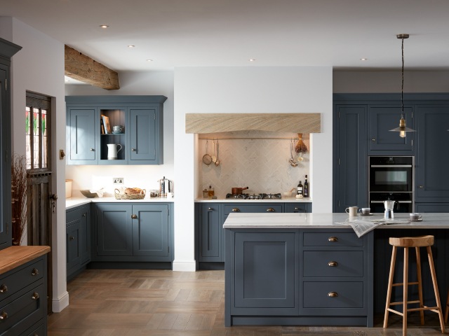 farmhouse style kitchen design with blue cabinets, white walls and wooden beams