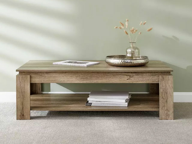 chunky wood effect furniture on grey carpet with decorative items
