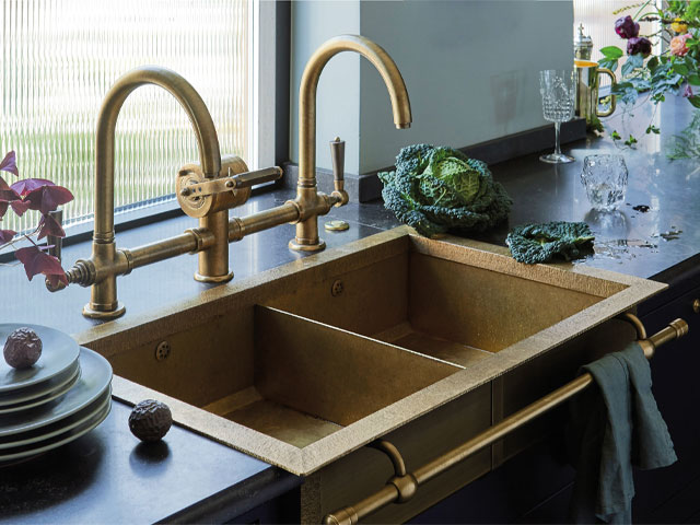 semi-recessed double sink in brass with matching taps and integrated towel rail