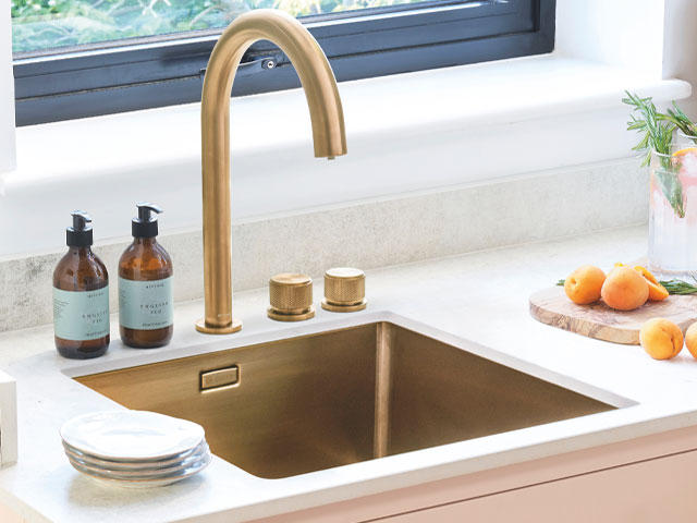 gold metallic kitchen sink with pink kitchen cabinets