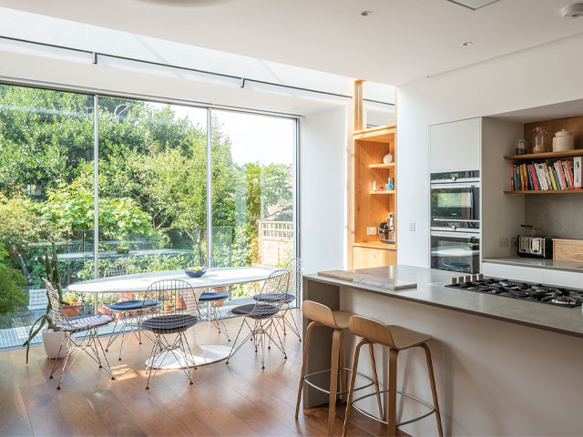 bright upper ground floor open-plan kitchen diner with rooflight and floor-to-ceiling windows