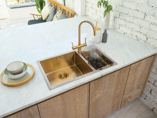 gold instant hot water tap with a gold sink in a white marble counter