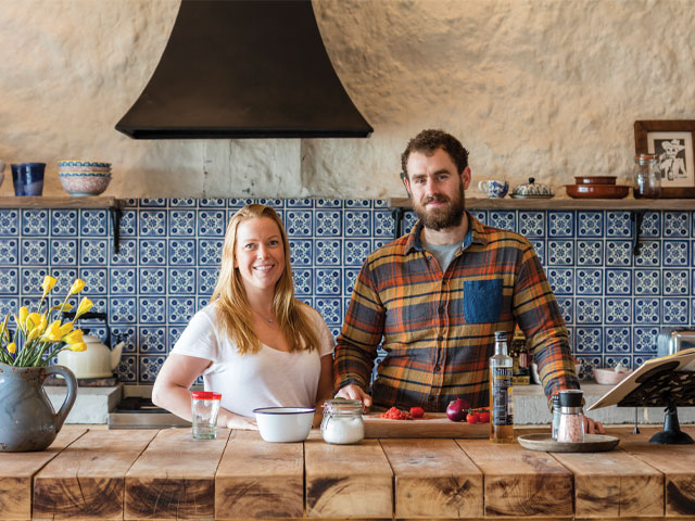 Vicky and Ed in the handmade kitchen in their Grand Designs cowshed conversion