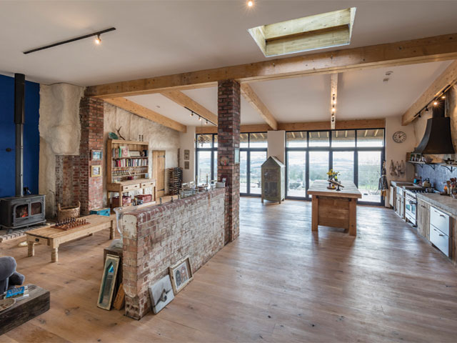 The open-plan living and dining space of the Grand Designs cowshed in Somerset faces south