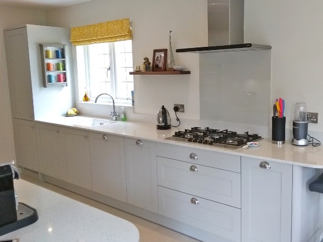 gallery kitchen with white walls and cabinets and plenty of open space