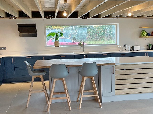 home extension with wooden ceiling beams and dining space