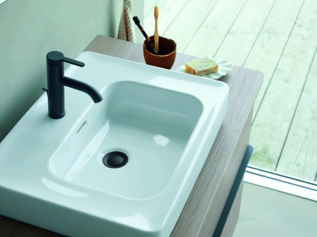 Philippe Starck bathroom sink with matt-black tap on wooden vanity unit
