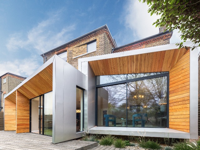 contemporary rear extension to a Victorian house in South Norwood with dramatic stainless steel clad boxes