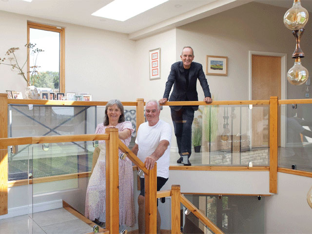 Kevin McCloud with Paul and Carol from the Grand Designs Bolton revisit episode