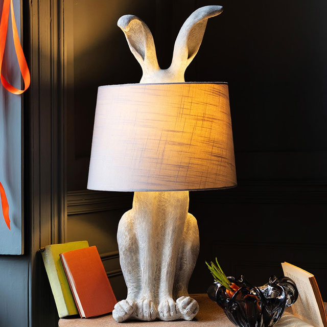 statement table lamp with a base in the shape of a hare, ears sticking out of the top of a white lampshape