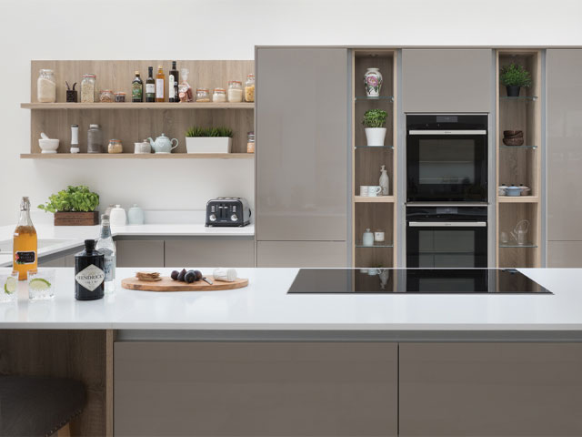 Modern grey kitchen with gloss cabinets and warm wooden shelving