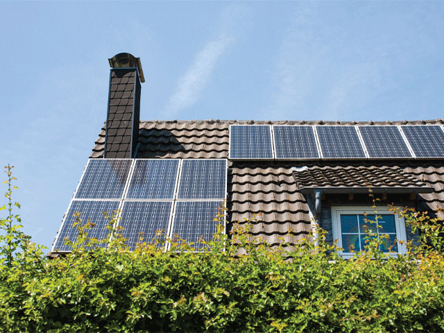 Photovoltaic roof panels on a tiled roof