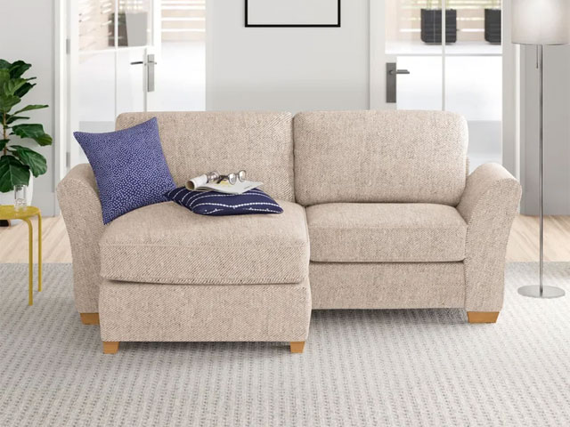 two-seater sofa with chaise and chunky wooden feet on a grey striped rug in a modern living room