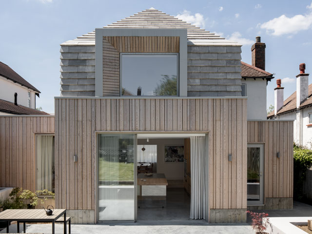 The home in Epsom, Surrey is clad in Siberian larch and grey clay tiles. Photo: Stale Eriksen