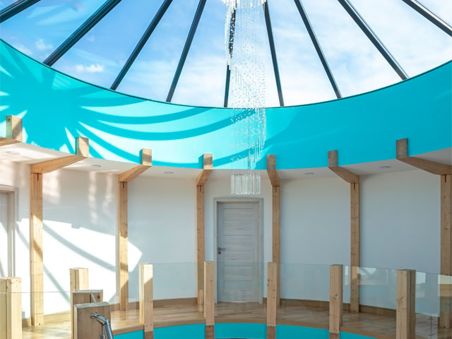 Lakeside timber roundhouse with large windows. Photo: Fiona Walker Arnott