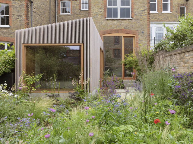 timber and glass extension on a brick terrace home in a conservation area