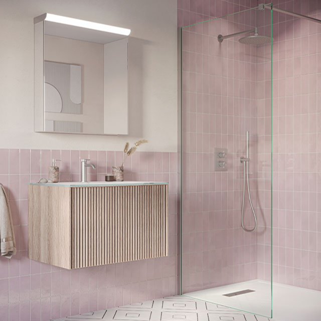 pink bathroom tiles, wooden vanity unit and walk-in shower with flush-fit tray and glass screen 