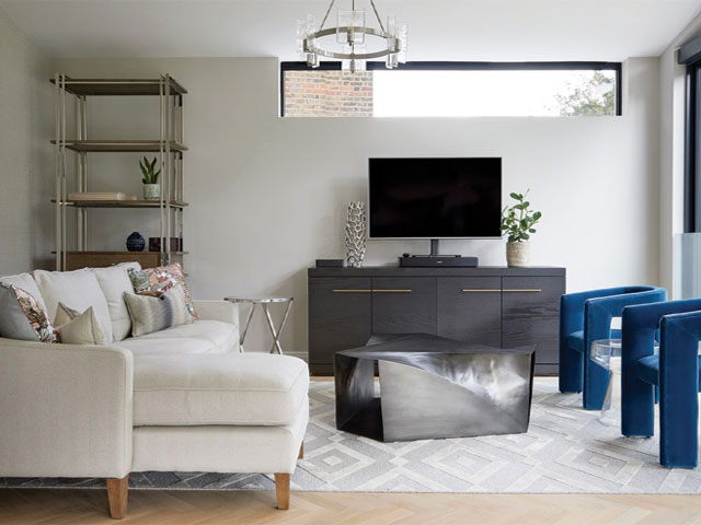 modern living room snug with floor-to-ceiling sliding doors opening to the garden