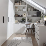 office in a loft extension with skylight window, white furniture and built-in wardrobes