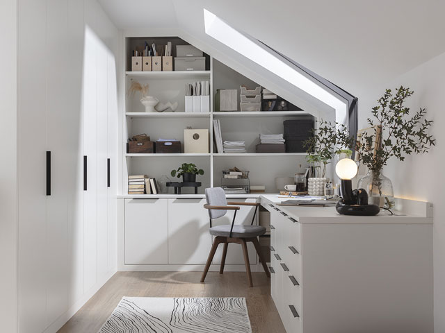 office in a loft extension with skylight window, white furniture and built-in wardrobes