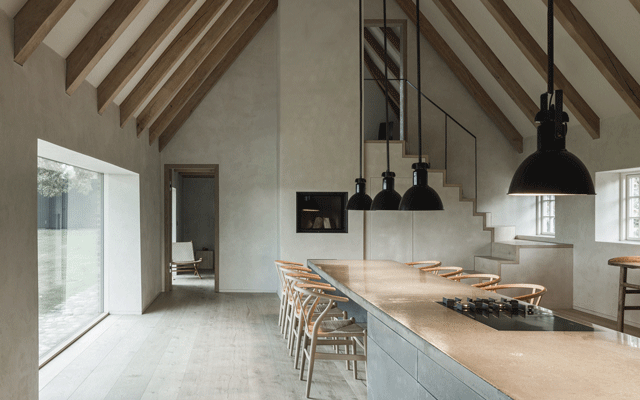 A double-height kitchen-diner in a thatched cottage extension