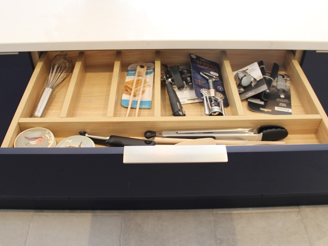 bespoke drawer pulled out to reveal plenty of storage for utensils