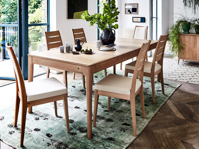 Romana extending oak dining table, available in three sizes, ladder back dining chair, and sideboard. Photo: Ercal
