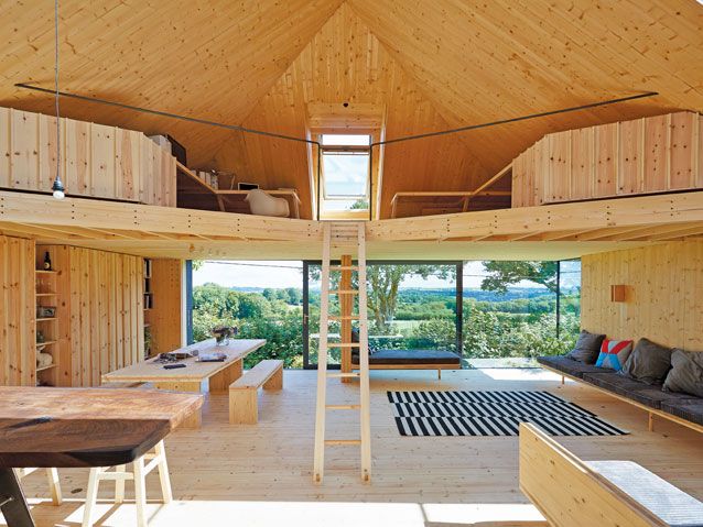 Grand Designs: Living in the country. Timber treehouse interior large ladder large glazing wooden table large
