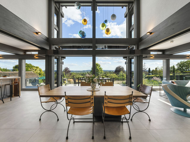 double-height open-plan kitchen diner with double-height windows in Huf Haus' Holly Blue house in Guildford
