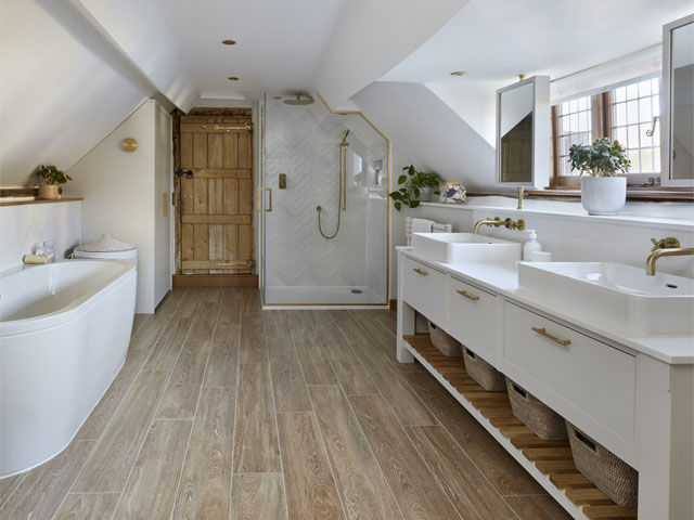 Large loft bathroom with double sink, gold trimmed fixtures and bathtub