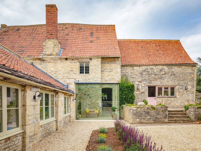 medieval cottage in Codrington, Gloucestershire, with stone walls, tiled roof and contemporary glass extension