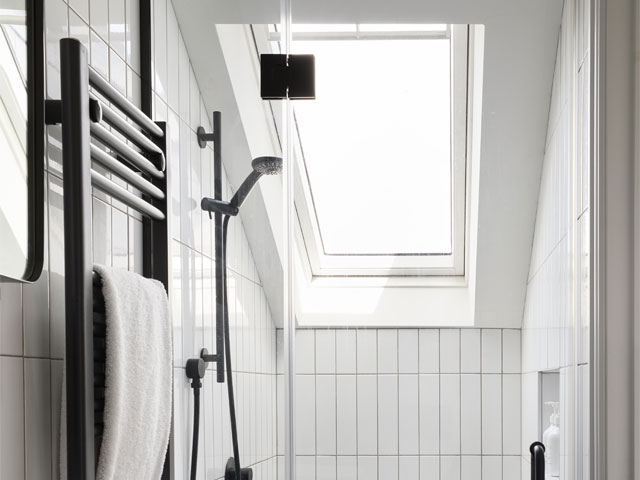 attic shower with rooflight and slim white tiles