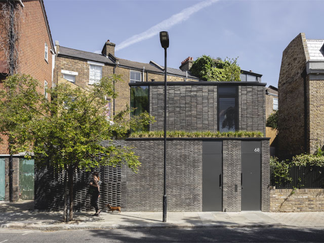 contemporary black-brick home on a small infill site in Hackney with no windows to the street on the ground floor 