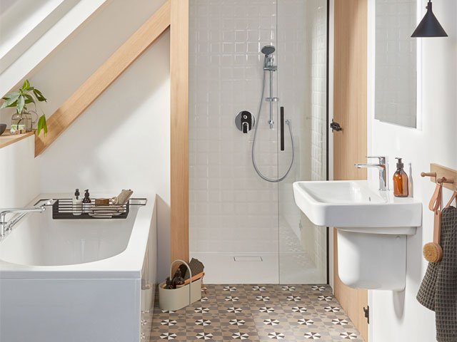 Loft wet room with pale pink tiles and small bathtub
