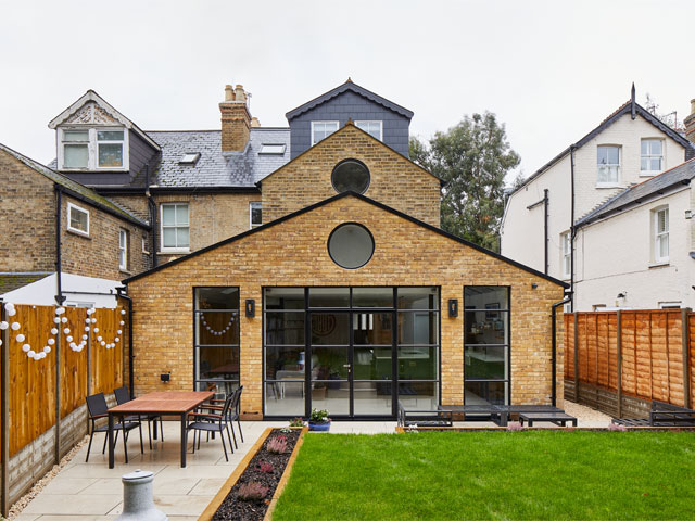 single-storey rear kitchen extension with crittall-style windows, patio for al fresco dining and grassy garden area 