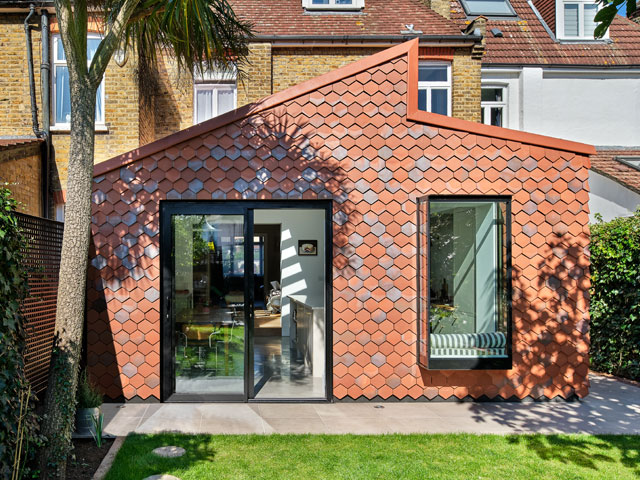 modern extension to a terraced house in Wimbledon with hexagon-shaped clay tiles and asymmetrical roof