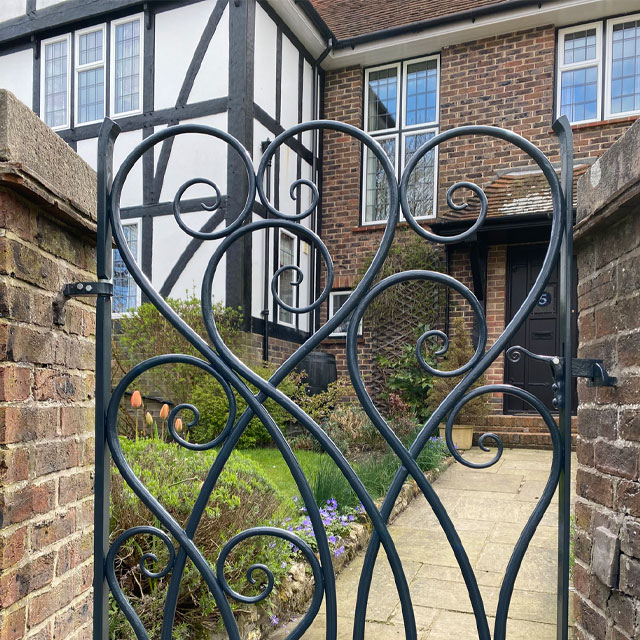 metal garden gate with ornate, curvy detailing